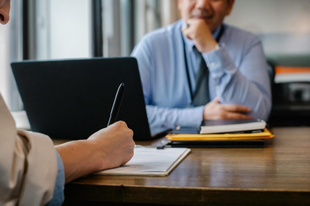 pexels-photo-5668858-5668858 Crop anonymous female filling questionnaire when applying for job sitting in employer office